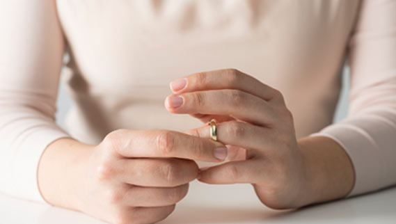 woman taking off wedding ring